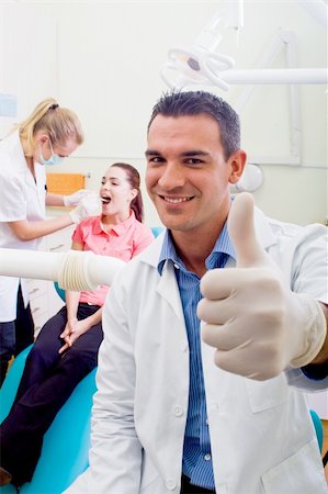 friendly male dentist giving thumb up sign Stock Photo - Budget Royalty-Free & Subscription, Code: 400-05175555