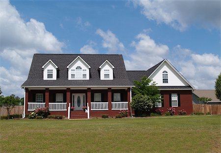 Two story residential home with with board siding on the facadeTwo story residential home with brick facade. Photographie de stock - Aubaine LD & Abonnement, Code: 400-05175753