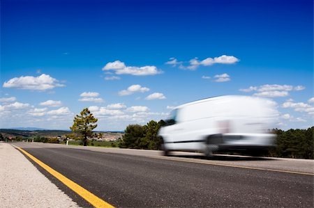 White van in a country road with some trees and a great blue sky above Stock Photo - Budget Royalty-Free & Subscription, Code: 400-05176653