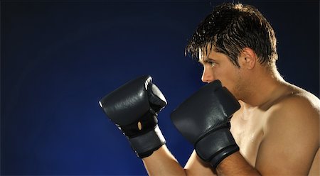 simsearch:400-08333281,k - The boxer. The young man in boxing gloves Stock Photo - Budget Royalty-Free & Subscription, Code: 400-05177224