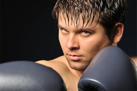 simsearch:400-08333281,k - The boxer. The young man in boxing gloves Stock Photo - Budget Royalty-Free & Subscription, Code: 400-05177227