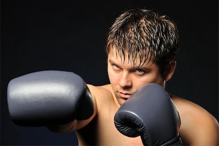 simsearch:400-08333281,k - The boxer. The young man in boxing gloves Stock Photo - Budget Royalty-Free & Subscription, Code: 400-05177228