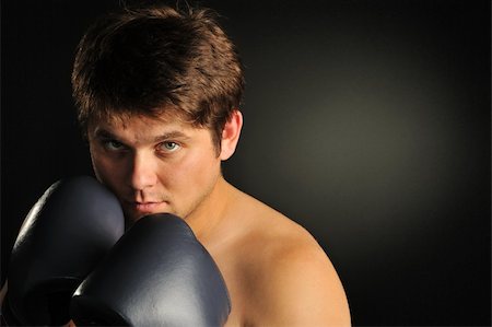 simsearch:400-08333281,k - The boxer. The young man in boxing gloves Stock Photo - Budget Royalty-Free & Subscription, Code: 400-05177229