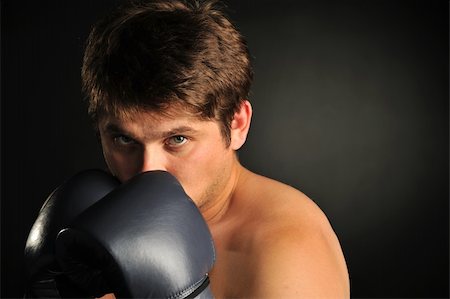 simsearch:400-08333281,k - The boxer. The young man in boxing gloves Stock Photo - Budget Royalty-Free & Subscription, Code: 400-05177223