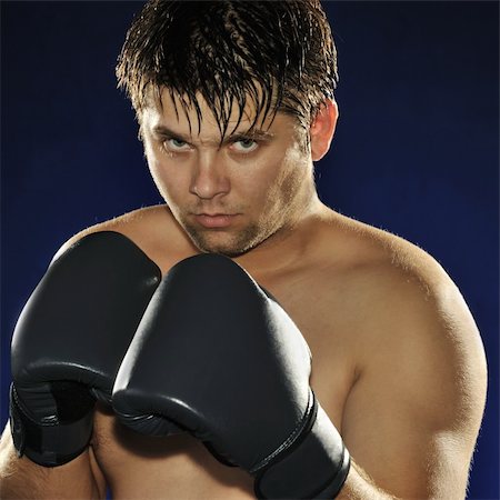 simsearch:400-08333281,k - The boxer. The young man in boxing gloves Stock Photo - Budget Royalty-Free & Subscription, Code: 400-05177234