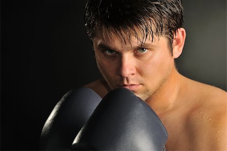 simsearch:400-08333281,k - The boxer. The young man in boxing gloves Stock Photo - Budget Royalty-Free & Subscription, Code: 400-05177230