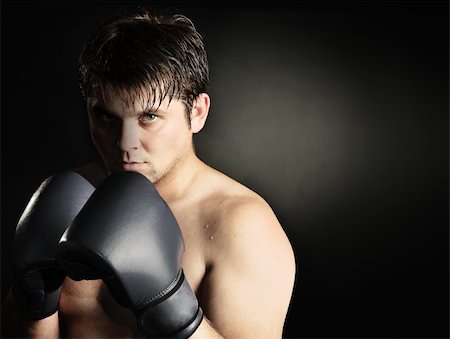 simsearch:400-08333281,k - The boxer. The young man in boxing gloves Stock Photo - Budget Royalty-Free & Subscription, Code: 400-05177232