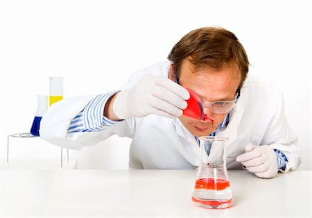 Chemist, dripping a yellow substance in a measuring beaker Stock Photo - Budget Royalty-Free & Subscription, Code: 400-05177694