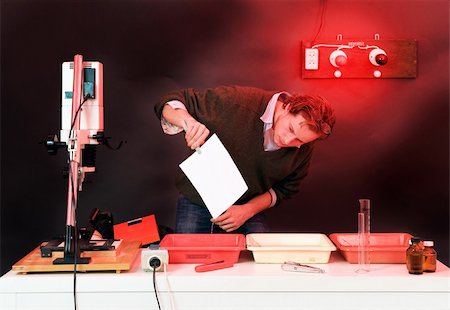 Photographer at work in a dark room, developing analogue prints Stock Photo - Budget Royalty-Free & Subscription, Code: 400-05177696