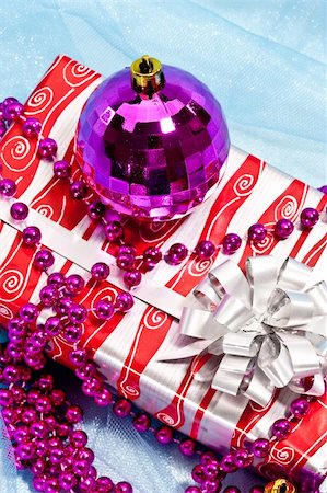 Holiday series: christmas gift with purple ball decoration and garland Stock Photo - Budget Royalty-Free & Subscription, Code: 400-05178334