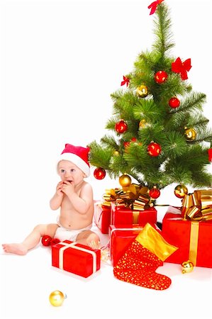 Baby in santa hat playing with Christmas decoration Stock Photo - Budget Royalty-Free & Subscription, Code: 400-05178645