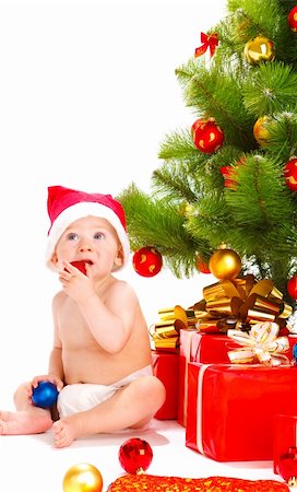 Baby in santa hat playing with Christmas decoration Stock Photo - Budget Royalty-Free & Subscription, Code: 400-05178646