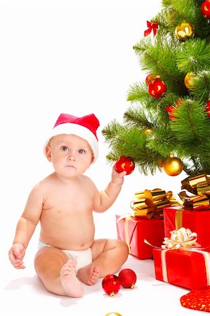 Baby in santa hat playing with Christmas decoration Stock Photo - Budget Royalty-Free & Subscription, Code: 400-05178647