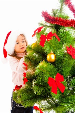 decorating small xmas tree - Cute girl helping to decorate Christmas tree Stock Photo - Budget Royalty-Free & Subscription, Code: 400-05178657