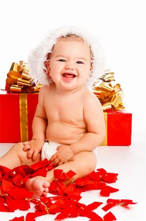 simsearch:400-06739427,k - Lovely baby girl in santa hat sitting near xmas presents Photographie de stock - Aubaine LD & Abonnement, Code: 400-05178652