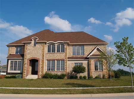 simsearch:400-05175746,k - Two story contemporary stone residential home with arched windows. Fotografie stock - Microstock e Abbonamento, Codice: 400-05179409