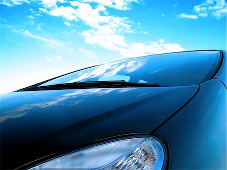 fast car close up - close up of a frontside of a car under a cloudy blue sky Stock Photo - Budget Royalty-Free & Subscription, Code: 400-05179509
