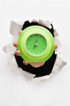 simsearch:400-04639602,k - Hand breakthrough wall holding green clock - one of the breakthrough series Stock Photo - Budget Royalty-Free & Subscription, Code: 400-05170268