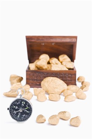simsearch:400-04639602,k - Guidance to wealth concept using compass and golden nuggets with treasure chest on background Stock Photo - Budget Royalty-Free & Subscription, Code: 400-05170280