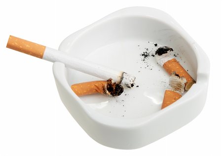 simsearch:400-04274877,k - White ashtray with a smoking butts and cigarette. Close-up. Isolated on white background. Photographie de stock - Aubaine LD & Abonnement, Code: 400-05170318