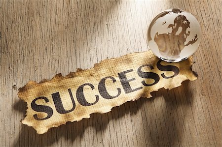 simsearch:400-04138611,k - Global success concept made from word success printed on burnt paper and a glass globe, and using hard lighting Stock Photo - Budget Royalty-Free & Subscription, Code: 400-05170334