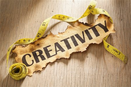 simsearch:400-04138611,k - Measurement for creativity concept by using tape measuring around burnt paper with word creativity printed on it. Stock Photo - Budget Royalty-Free & Subscription, Code: 400-05170338