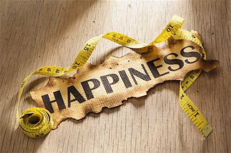 simsearch:400-04138611,k - Measurement for happiness concept by using tape measuring around burnt paper with word happiness printed on it. Stock Photo - Budget Royalty-Free & Subscription, Code: 400-05170339