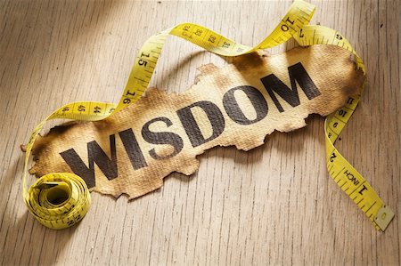 simsearch:400-04138611,k - Measurement for widsom concept by using tape measuring around burnt paper with word wisdom printed on it. Stock Photo - Budget Royalty-Free & Subscription, Code: 400-05170340