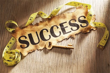 simsearch:400-04138611,k - Measuring success concept using burnt paper with word success printed on it and golden key surrounded by measuring tape Stock Photo - Budget Royalty-Free & Subscription, Code: 400-05170359