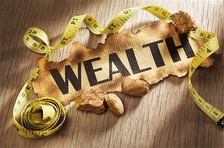 simsearch:400-04138611,k - Measuring wealth concept using burnt paper with word wealth printed on it and golden rocks surrounded by measuring tape Stock Photo - Budget Royalty-Free & Subscription, Code: 400-05170362
