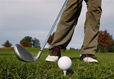 simsearch:400-05038623,k - A golfer in action on a practice range, hitting the ball with a club. Stock Photo - Budget Royalty-Free & Subscription, Code: 400-05171142