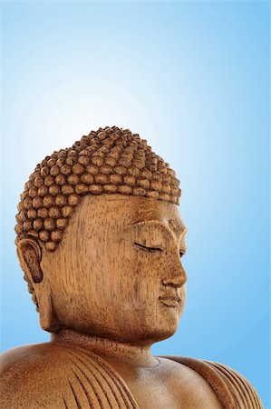 simsearch:400-05154191,k - Head of a wooden buddha over blue bacground with white central glow. Stock Photo - Budget Royalty-Free & Subscription, Code: 400-05172763