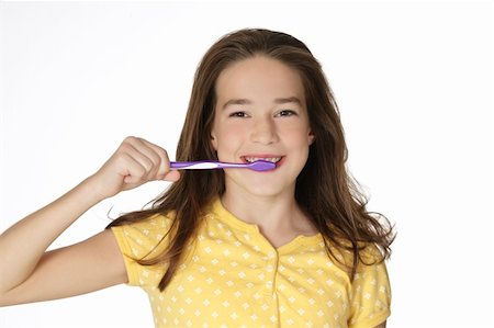 simsearch:400-06327889,k - Cute Caucasion girl brushing her teeth isolated on a white background Photographie de stock - Aubaine LD & Abonnement, Code: 400-05172777