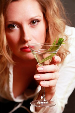 disapproving black woman - Beautiful woman with a glass of martini. Glass in a zone of sharpness, the rest is dim Stock Photo - Budget Royalty-Free & Subscription, Code: 400-05184903
