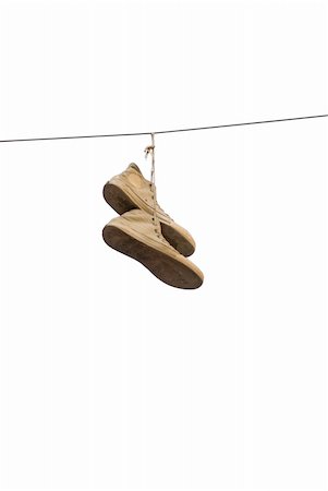 A pair of old sneakers hanging from a cable, isolated on white Foto de stock - Super Valor sin royalties y Suscripción, Código: 400-05184922