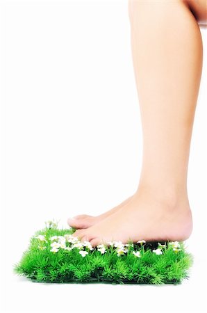 foot daisy - woman legs walking on small peace of green grass isolated on white representing last oasis concept Stock Photo - Budget Royalty-Free & Subscription, Code: 400-05185177