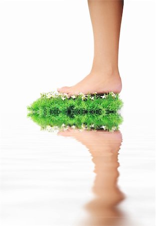 foot daisy - woman legs walking on small peace of green grass isolated on white representing last oasis concept Stock Photo - Budget Royalty-Free & Subscription, Code: 400-05185179