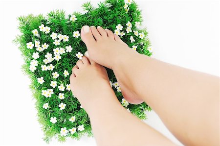 foot daisy - woman legs walking on small peace of green grass isolated on white representing last oasis concept Stock Photo - Budget Royalty-Free & Subscription, Code: 400-05185184