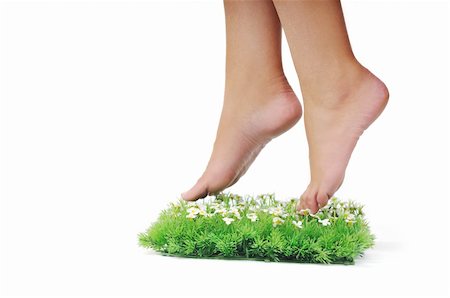 foot daisy - woman legs walking on small peace of green grass isolated on white representing last oasis concept Stock Photo - Budget Royalty-Free & Subscription, Code: 400-05185188