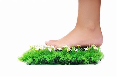foot daisy - woman legs walking on small peace of green grass isolated on white representing last oasis concept Stock Photo - Budget Royalty-Free & Subscription, Code: 400-05185181