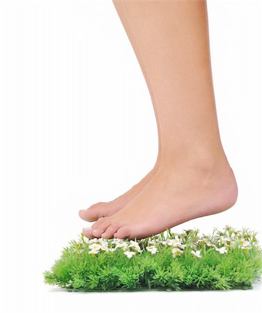foot daisy - woman legs walking on small peace of green grass isolated on white representing last oasis concept Stock Photo - Budget Royalty-Free & Subscription, Code: 400-05185190