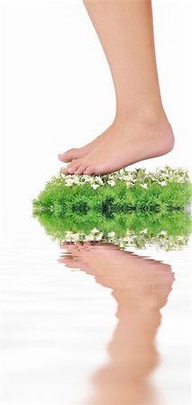 foot daisy - woman legs walking on small peace of green grass isolated on white representing last oasis concept Stock Photo - Budget Royalty-Free & Subscription, Code: 400-05185191