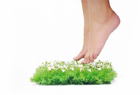foot daisy - woman legs walking on small peace of green grass isolated on white representing last oasis concept Stock Photo - Budget Royalty-Free & Subscription, Code: 400-05185192