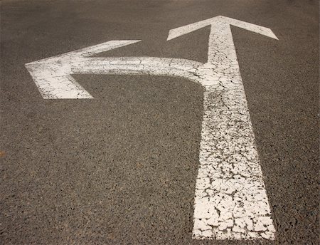 White arrow on the road pointing in two directions Stock Photo - Budget Royalty-Free & Subscription, Code: 400-05185769