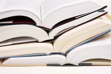 Stack of opened text books on a white background. Stockbilder - Microstock & Abonnement, Bildnummer: 400-05186177