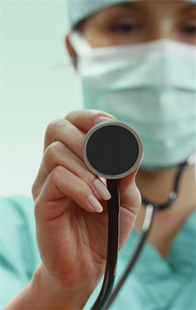 Female doctor with stethoscope in an emergency room lighting environment.Selective focus on the stethoscope. Stock Photo - Budget Royalty-Free & Subscription, Code: 400-05186189