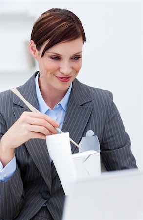 simsearch:689-03124356,k - Businesswoman eating chinese food with chopstick at work Stock Photo - Budget Royalty-Free & Subscription, Code: 400-05186279
