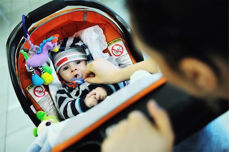 parents shopping trolley - happy young family in shopping centre indoor Stock Photo - Budget Royalty-Free & Subscription, Code: 400-05186336