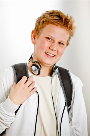 Teenage boy outside classroom with backpack and headphones Stock Photo - Budget Royalty-Free & Subscription, Code: 400-05187147