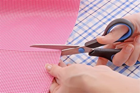 Dressmaker cuts scissors fabrics Stock Photo - Budget Royalty-Free & Subscription, Code: 400-05187178